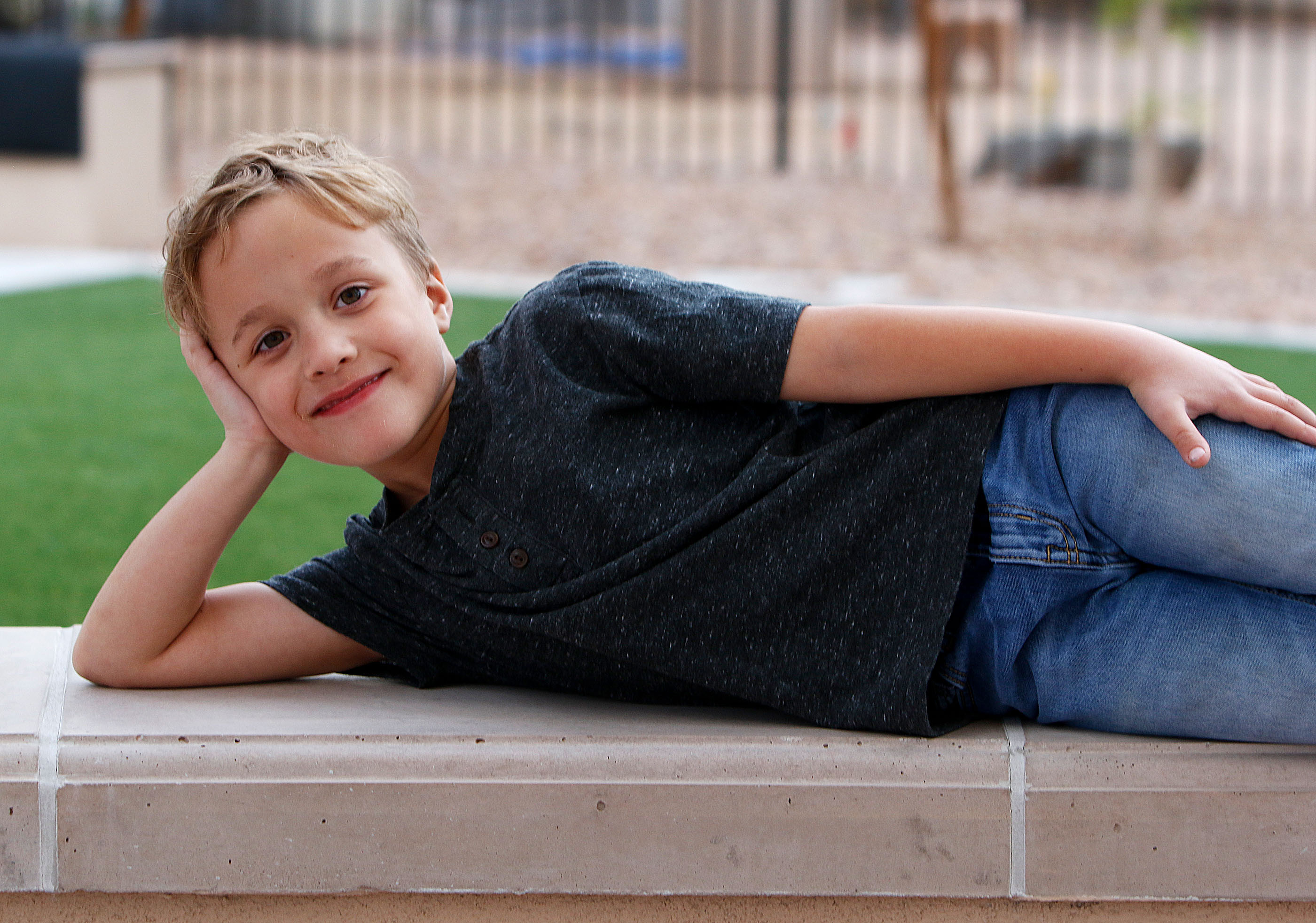 CMN Champion child 2025 Miles lounges on a bench